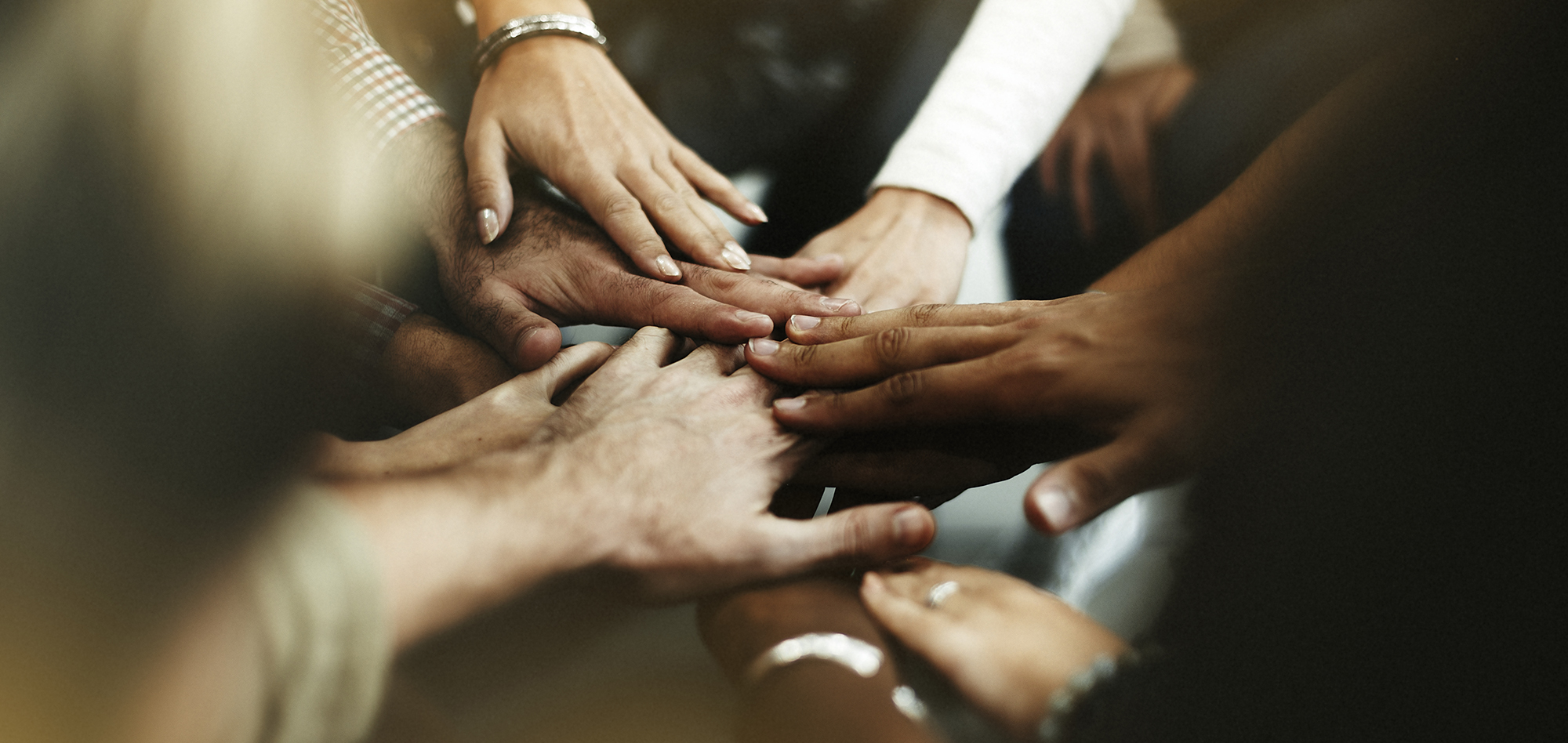 Closeup of diverse people joining their hands