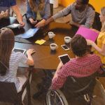 Business executives interacting with each other during meeting in office