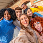 Friends pulling faces while taking a selfie in the city